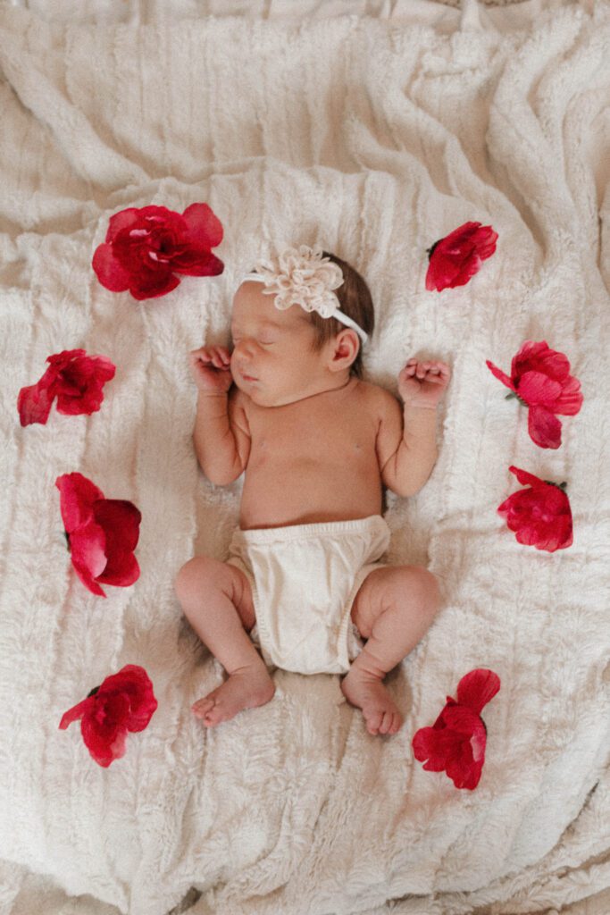 Baby laying sleeping with a wreath of flowers