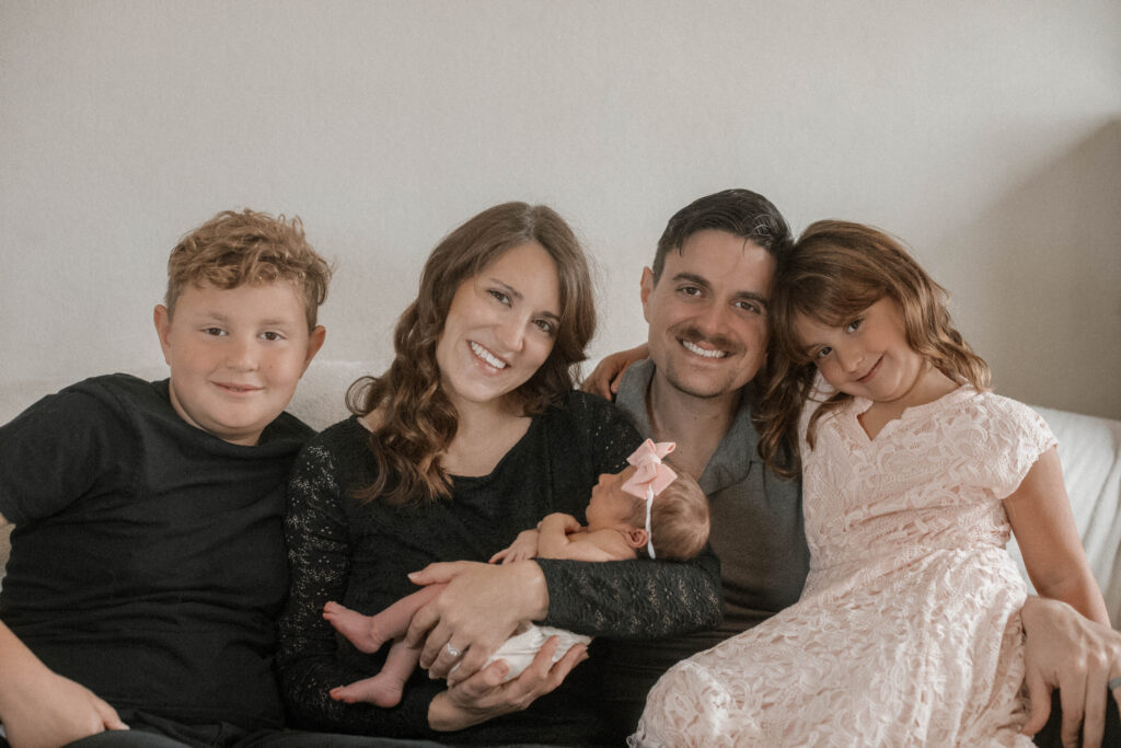 Beautiful family of five, mom holds her newborn