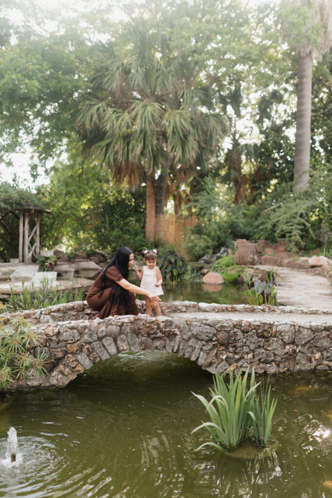 Mom embraces her little girl during Family Photos at the McNay Museum