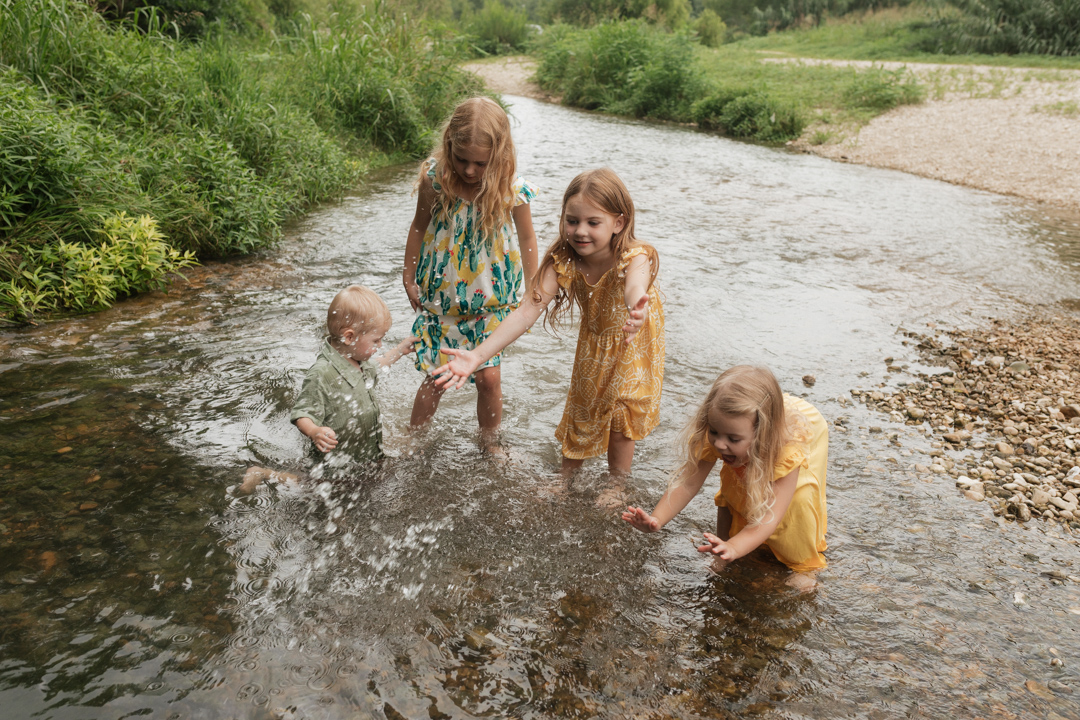 Four kids play and cool off in the Cibolo Creek.